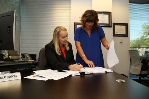 three working women reviewing contract