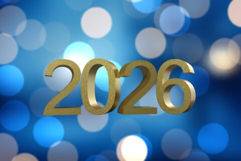 blue background with light flares with the year 2026 in gold overlaid on top.